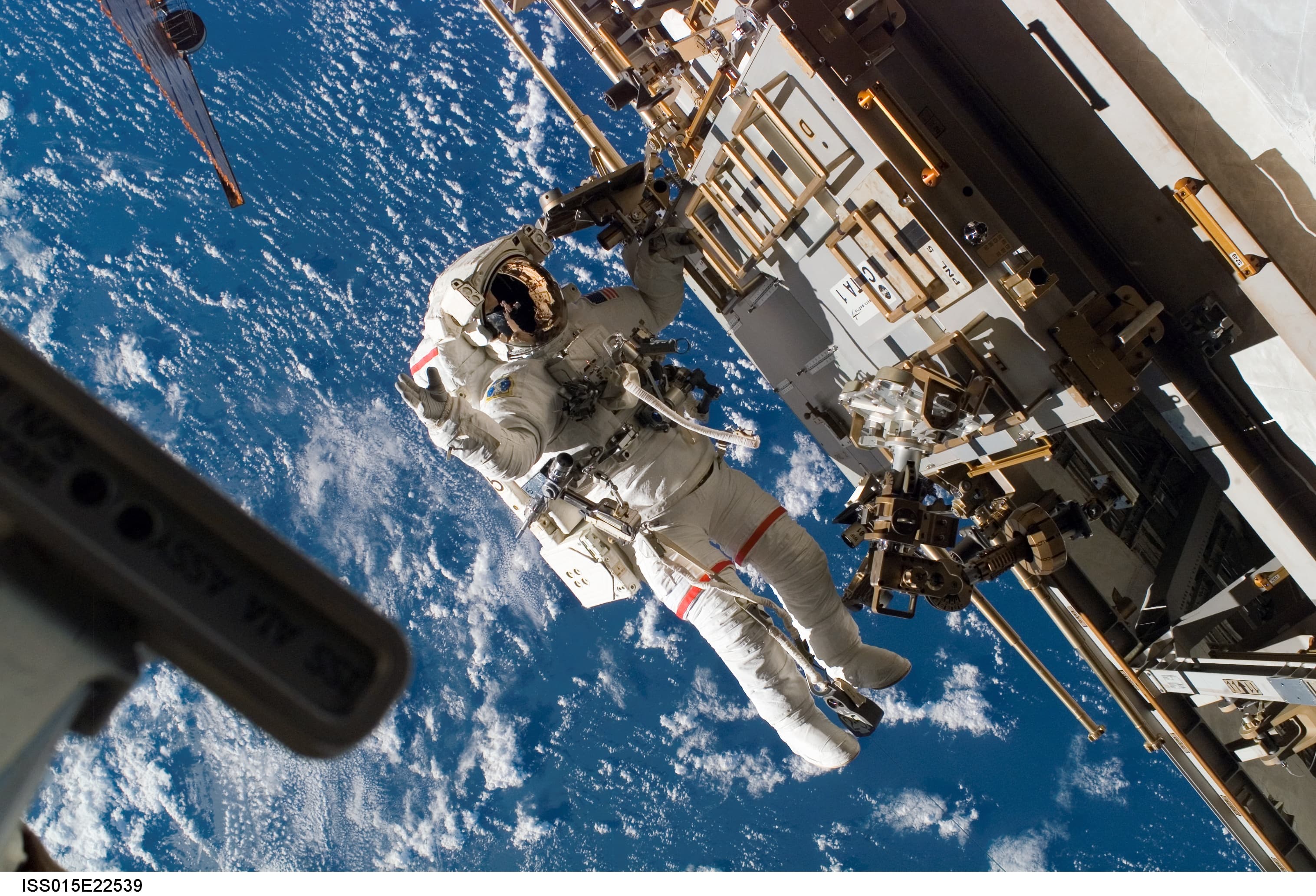 An astronaut performing a spacewalk above Earth
