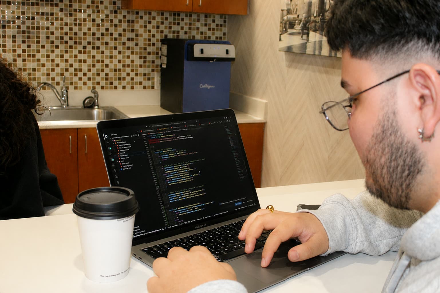 A DRACO member writing the airbrakes control software on a laptop